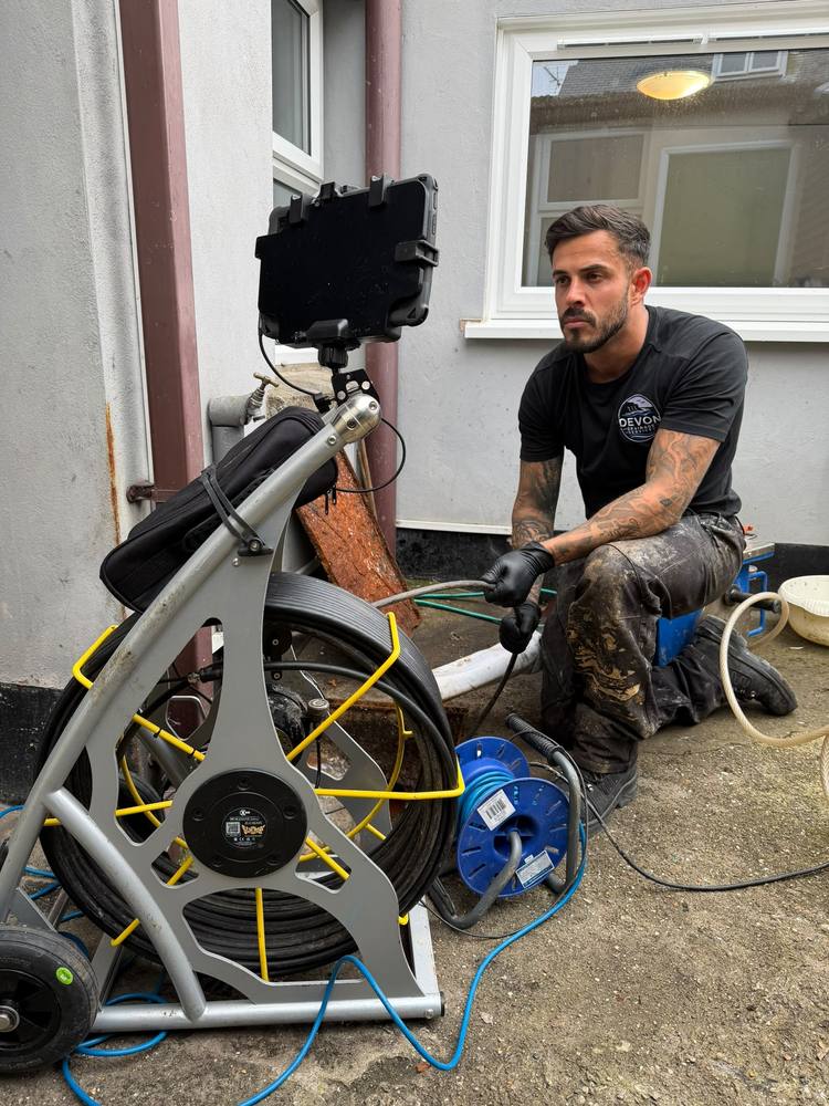Devon Drainage Services engineer setting up CCTV drain inspection equipment